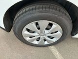 a close up of a tire on a white car