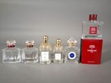 several bottles of perfume sitting next to each other on a table