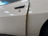 a white car with a door handle on the side of it