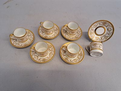 six cups and saucers sitting on a table