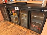 a black counter with a glass door that has bottles on it