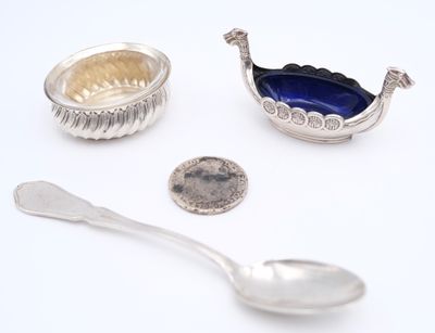 two spoons, a spoon and a spoon rest on a white surface