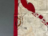 an old piece of cloth with a red heart on it