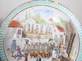 a plate with a picture of a group of people on it