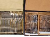 a lot of silverware in a box on the table