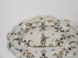 a plate that has a picture of a man and a dog on it