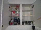 a white cabinet with a lot of different items on it
