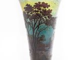 a glass vase with a painting of a tree on it