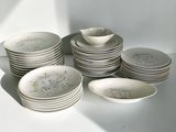 a lot of plates and bowls sitting on a table
