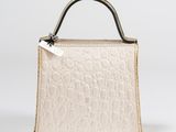 a white purse with a metal handle on a white background
