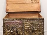 an old wooden chest with carvings of people and animals on it