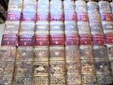 many old books stacked on top of each other