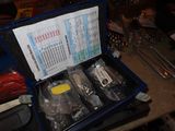 a blue case with tools in it sitting on a table