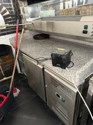 a mop that is sitting on the counter next to a pizza oven