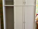 an image of a closet in a room with a wallpapered wall