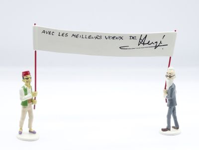 two figurines of a man holding a sign and a flag