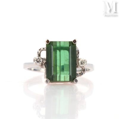 an image of a green tourmaline and diamond ring on a white background