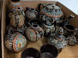 a cardboard box filled with many different types of vases