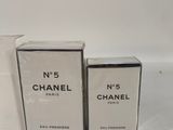 three boxes of chanel perfume sitting next to each other on a table