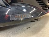 a close up of a car ' s bumper with a sticker on it
