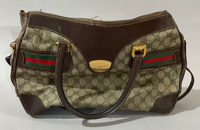 beige and brown gucci handbag with red, green, and red stripes