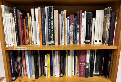 a book shelf with many books on it in a room