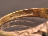 a close up of a gold ring with a stone in it