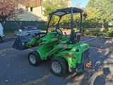 a green tractor that is parked in the parking lot