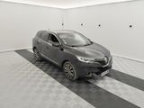 the grey car is parked in the garage on the checkered floor