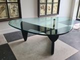 a glass table with a glass top in the middle of a room