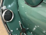 a close up of a green car with a steering wheel