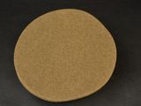 a close up of a brown disc on a black surface