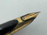 a close up of a fountain pen with a black nib