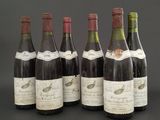 several bottles of wine are lined up on a table