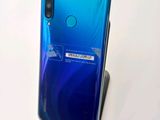 a close up of the back of a blue and white phone