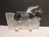 a figurine of a horse and a dog on a boat