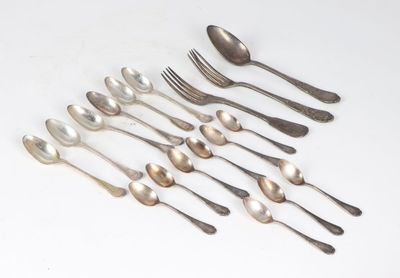 a lot of spoons and forks on the table