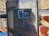 a person holding up a digital clock on a bike