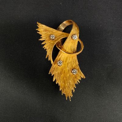 un gros plan d'une bague en or sertie de diamants sur fond noir
