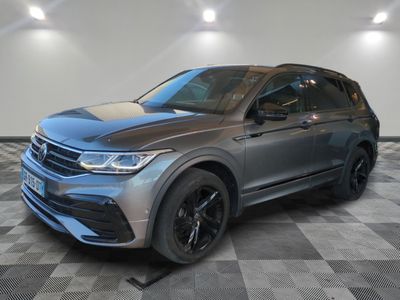 a grey volkswagen suv parked in a garage