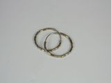 pair of gold tone hoop earrings on a white surface