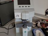 a machine that is sitting on a desk next to a laptop