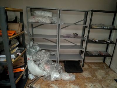 a room that has a bunch of shelves in it