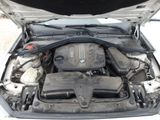 a car engine with its hood open on the street