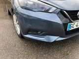 a blue car parked on the side of the road