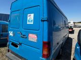 a blue van that is parked in a lot