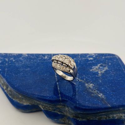 a close up of a silver ring on a blue stone