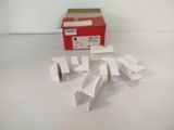 several pieces of white paper are sitting on a table next to a red box