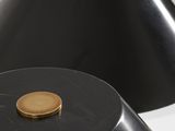 a pair of black lamps with a gold button on the top