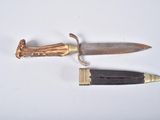 a knife and a knife holder on a white surface